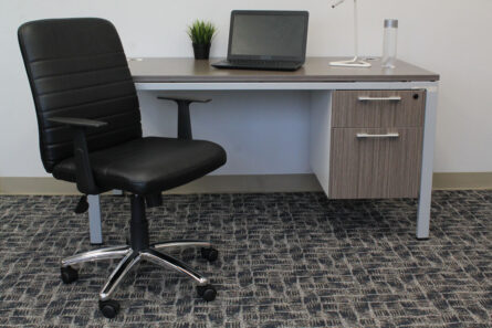 Office setup with a Retro Task Chair with Black T-Arms, a desk containing a laptop and a small potted plant, on a carpeted floor.