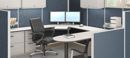 Modern office Cubicles with an ergonomic chair, l-shaped desk, dual-monitor setup, and various office supplies.