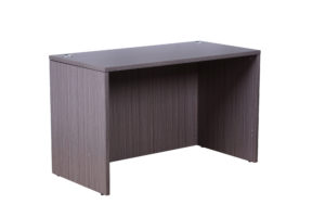 A simple TOS Desk Shell 48X24, Driftwood with panel legs, viewed against a plain white background.