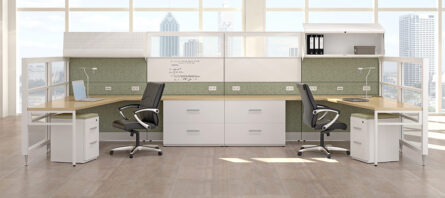 Modern office space with two Interra Series desks, ergonomic chairs, and storage cabinets, overlooking a city through large windows.