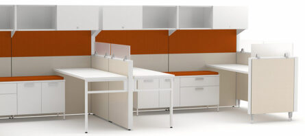 Modern Interra Series office cubicles with white desks, orange privacy panels and overhead cabinets on a light background.