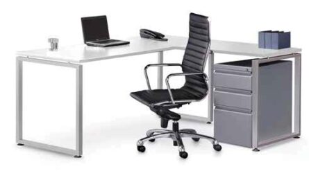 Modern office Elements L shaped desk setup with a laptop, black office chair, and a mobile pedestal drawer unit on a white background.