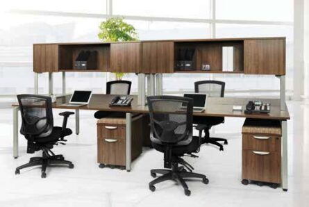 Modern office space featuring a cluster of Elements desks with overhead #3 (Single Unit) in black office chairs, laptops, and partition panels.