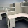Empty TOS Quickship Cubicle Systems with white desks and gray partitions, featuring overhead cabinets and filing drawers.