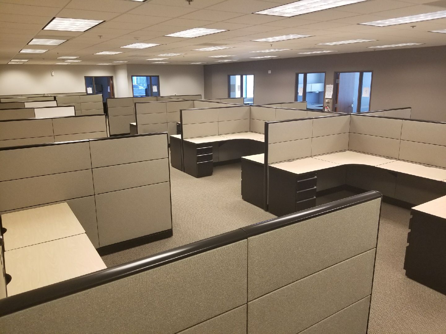 A large office with many cubicles and desks.