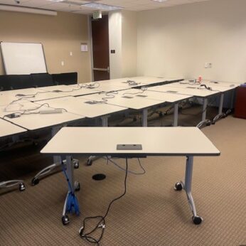 Empty conference room with tables and chairs.