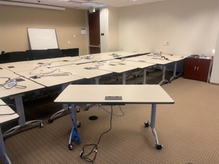 Empty conference room with tables and chairs.