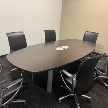 Meeting room with a table and chairs.