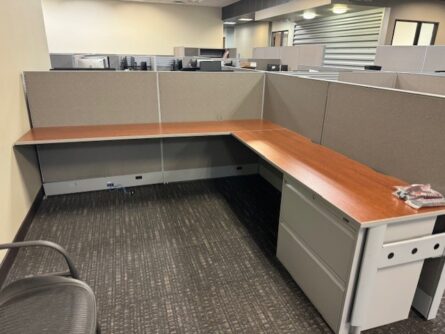 L-shaped office desk with file cabinets.