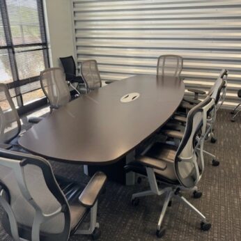 Modern conference room with table and chairs.