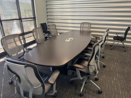 Modern conference room with table and chairs.