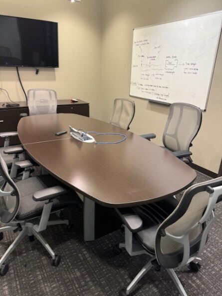 Conference room with table and chairs.