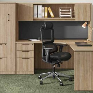 Wooden office desk with black chair setup.