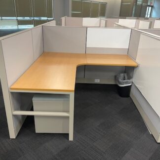 Empty office cubicle with wooden desk.